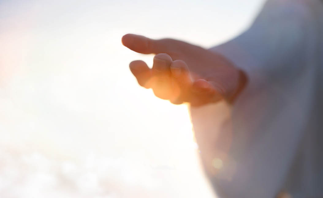 Jesus Christ with open arms reaching out in the sky, hand gestures of Jesus dying on the cross and resurrected, heaven and salvation, faith and love, easter concept